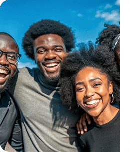 Group of three friends smiling closely outdoors
