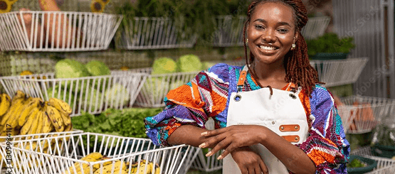 Cooperative member standing with produce